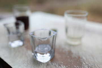 Forgotten glasses with alcohol on table.
