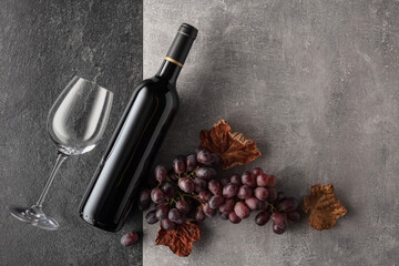 Red wine with grapes on a stone background.