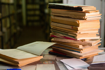 Very old books sitting on the shelves in the library. Books as a symbol of knowledge.