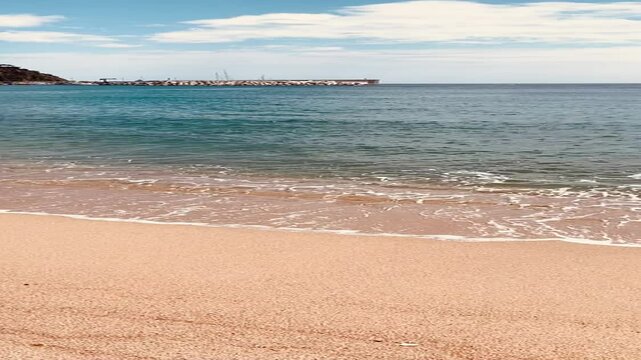 Blanes beach on the Costa Brava. Turquoise crystalline waters of the Mediterranean Sea. Costa brava tourist beaches. Catalonia, Spain.