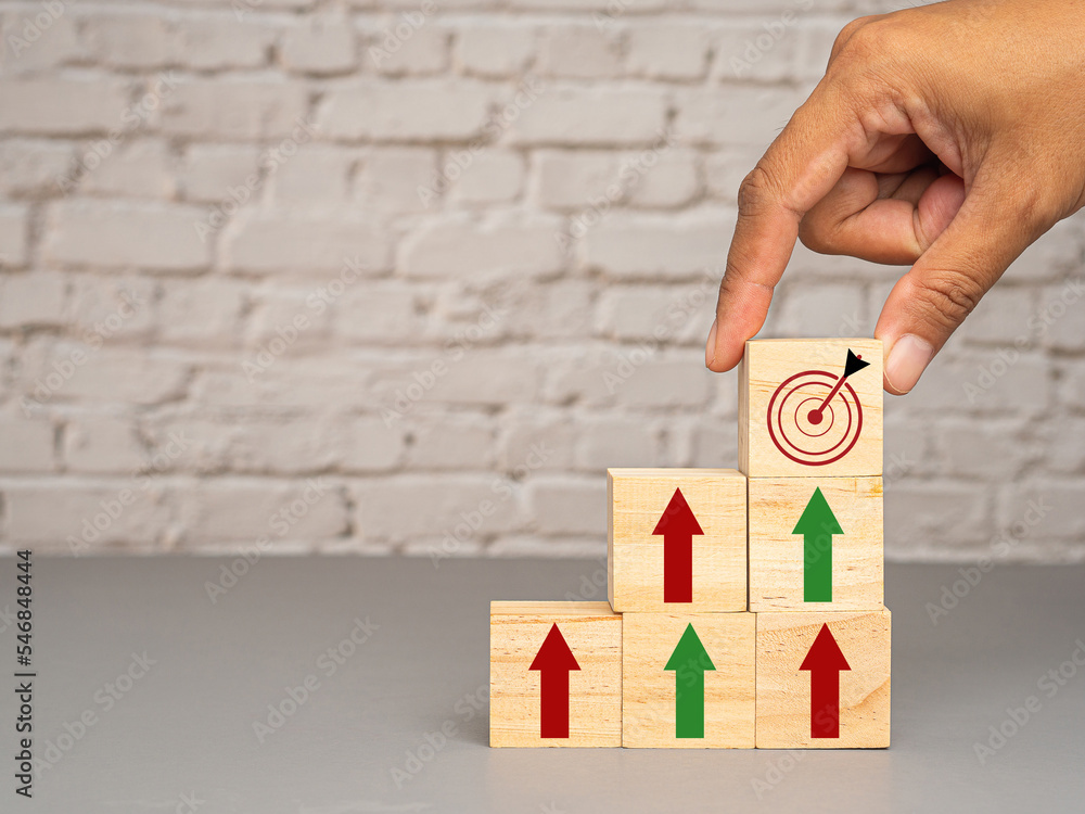 Poster wooden cubes with red and green arrows up a point to target icon with a gray background