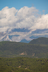 Snow covered mountain with blue sky, cloud and fog