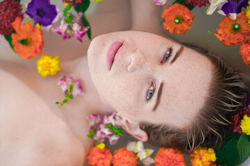 Caucasian woman in floral bath looking at camera