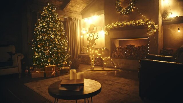 Christmas and New Year interior decoration. Green tree decorated, flashing garland, illuminated lamps. Fireplace and xmas tree. Cozy Christmas atmosphere. 4K