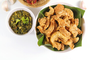 Homemade crispy pork rind with green chili paste. Local food of northern Thailand.