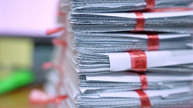 stack of documents on desktop in office.