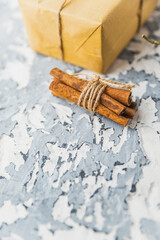 Christmas still life on the windowsill. Concrete background, gifts, candles and garlands