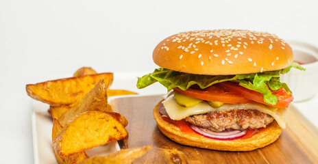 tasty burger and tasty french fries on wooden plate  on white background