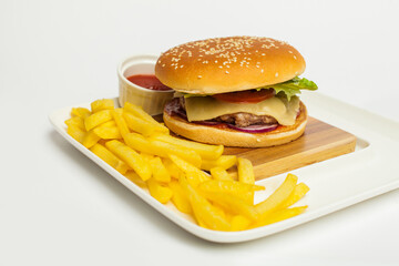 gourmet beef burger and french fries on wooden table on white background.