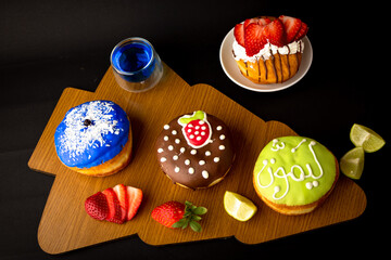 tasty chocolate and strawberry donuts with tea and coffee with beautiful accessories 