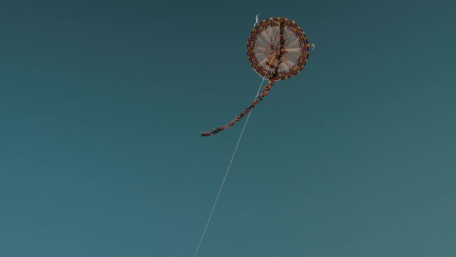 Giant Kite Flying In The Blue Sky During All Saints' Day Celebration In Sumpango, Guatemala - low angle