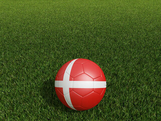 Fototapeta na wymiar Football in Denmark flag on green grass. 3d rendering