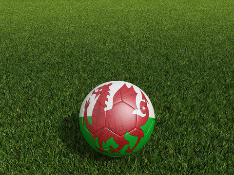 Football in Wales flag  on  green grass. 3d rendering