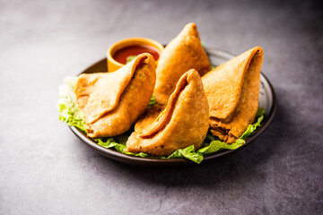 samosa or singara. Indian fried or baked pastry with a savory filling, spiced potatoes, onion, peas