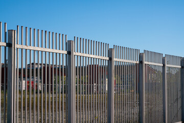 Borders: the fence with steel metal grate. Detail of the grate is made with a resistant and solid...