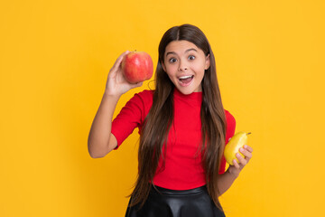 smiling amazed child hold apple and pear on yellow background