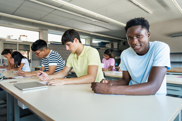 Smiling African teenager Male student doing exercise at High School