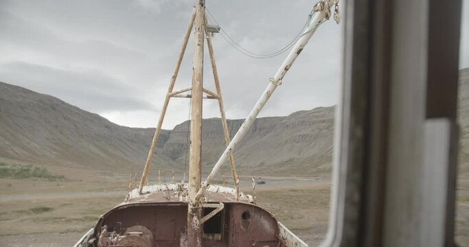 View Of Rusty Mast And Deck Of Ghost Ship Through Its Window. Gardar BA 64 In Iceland. dolly-in shot