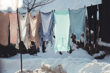 washed clothes hang on a string in the cold, hardened.