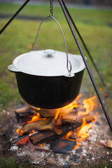 cauldron on fire for cooking hot food in nature.