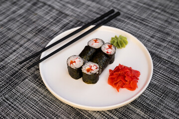 a dish of delicious sushi rolls