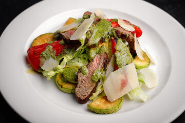 Salad with veal, roasted vegetables, and Parmesan cheese