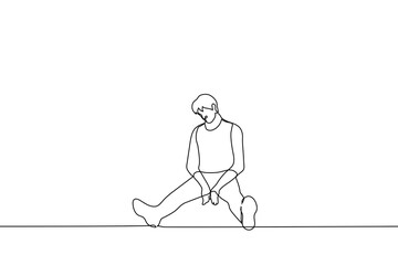 Fototapeta na wymiar sad man sits on the floor with his head down and legs wide apart - one line drawing vector. concept of sadness, apathy, depression, loss, depression, loneliness