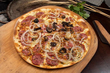 Brazilian pizza with pepperoni, cheese, onion and black olive
