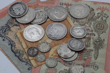 Vintage money background with silver coins and banknotes