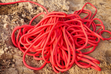 A red rope on the sand. Climbing equipment. Cable car access