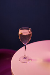 cocktail with alcohol in chilled cocktail glass, on white table