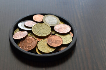 Euro cent coins on wood table.  Copy space is on the right side. 