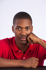 Thoughtful Black man in a red shirt