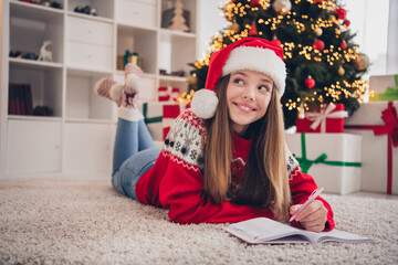 Photo of cute pretty teenager little lady lying carpet floor thinking new year present enjoy time magic season miracle room house indoors