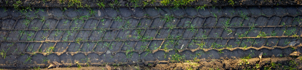 track wheel pattern. Tire track panorama texture. Wheel track on mud. Tyre track on dirt sand