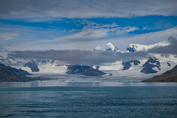 Glaciers and mountains rise above turquoise sea in south georgia