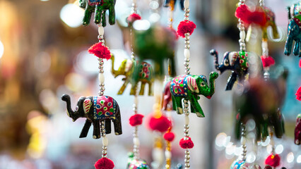 Beautiful colorful handmade wind chimes with bells, decorated toy elephant model Rajasthan India....