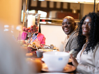 Smiling family sitting at Thanksgiving table