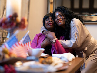 Women hugging at Thanksgiving dinner