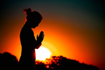 Fototapeta na wymiar Strong woman raising her hands on sunset background