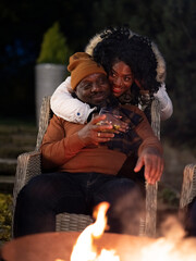 Smiling mature couple embracing on patio at night