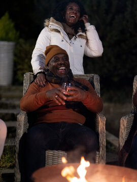 Smiling Mature Couple Relaxing On Patio At Night