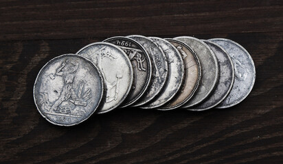 Many silver russian coins half ruble on the wooden table