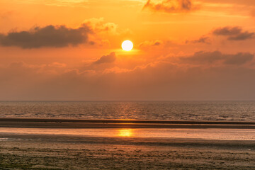 Scenic view of sunset over Deauville beach in Normandy, France against dramatic golden sky