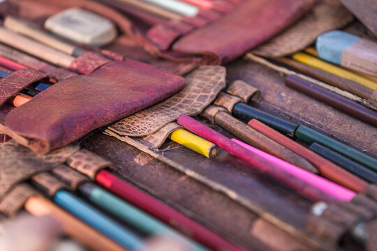 Close up of old drawing pencils set in leather bag at a flea market in Provence