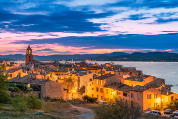 Scenic view of Saint Tropez after sunset with city lights turned on