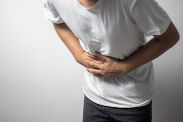 man having abdominal pain on white background