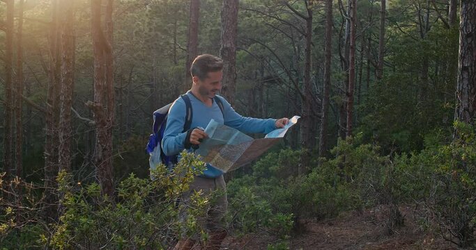 Male traveler reading map