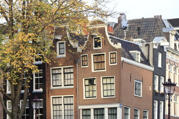 Fototapeta na wymiar Amsterdam Reguliersgracht Canal Twin House Facades with Autumn Foliage, Netherlands