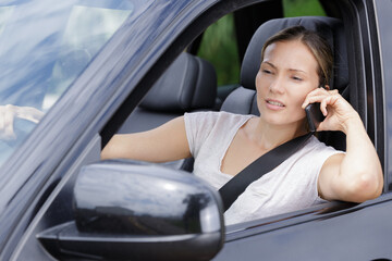 female driver using telephone whilst behind the wheel